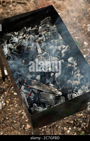barbeque ash in a grill in a garden, summer time vacation Stock Photo