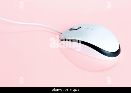 White minimalist computer mouse on pastel pink background. Stock Photo