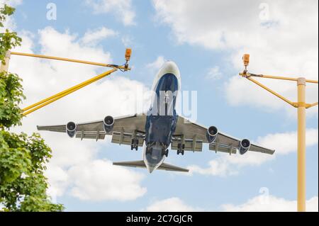large passenger jet on landing approach to an airport with its undercarriage down Stock Photo