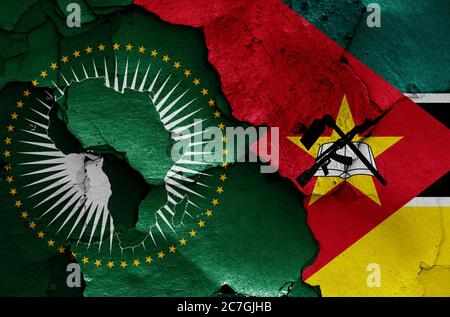flags of African Union and Mozambique painted on cracked wall Stock Photo