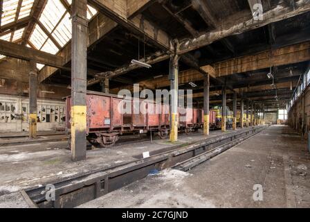 Interior shot of an old warehouse with old trains stored inside Stock Photo