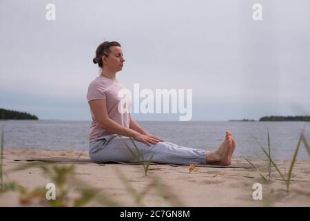 Young sporty woman practicing yoga, doing Dandasana pose Stock Photo