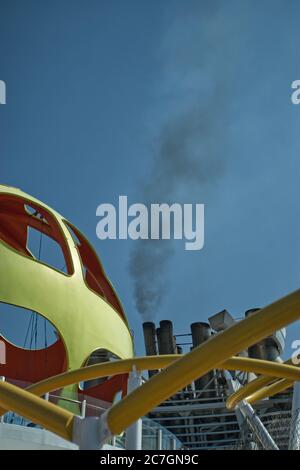 vertical shot black pollution smoke coming out of cruise ship Stock Photo