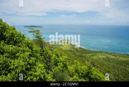 High angle view of the lush hills, Buck Island and Caribbean Sea from the Goat Hill hike on the East End of St. Croix in the US Virgin Islands Stock Photo