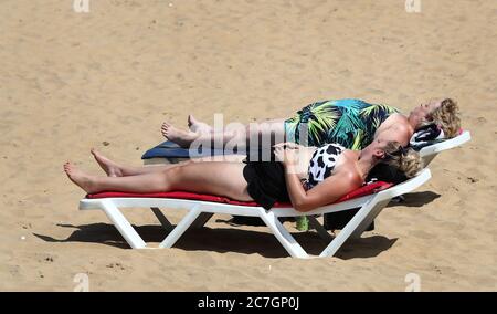 People enjoy the warm weather on the beach in Margate, Kent, as parts of the UK enjoy warm weather. Stock Photo