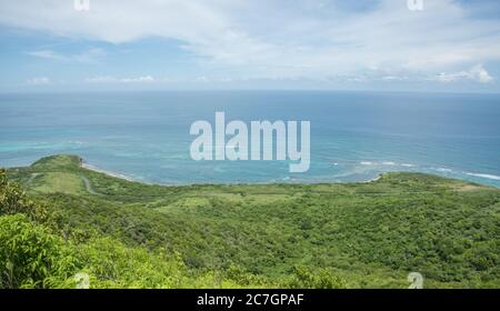View of the lush greenery and Caribbean Sea with coastal road from the Goat Hill hike on the East End of St. Croix in the US Virgin Islands Stock Photo