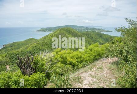 Panoramic view of the lush, rolling hills and Caribbean Sea from the Goat Hill hike on the East End of St. Croix in the US Virgin Islands Stock Photo