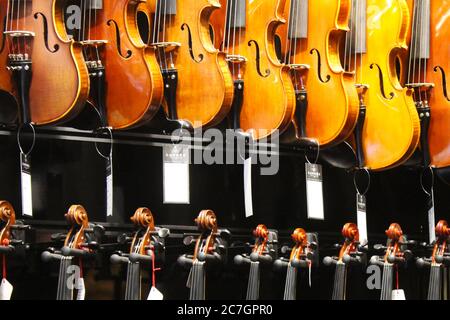 Large group of violins in the music instruments market Stock Photo