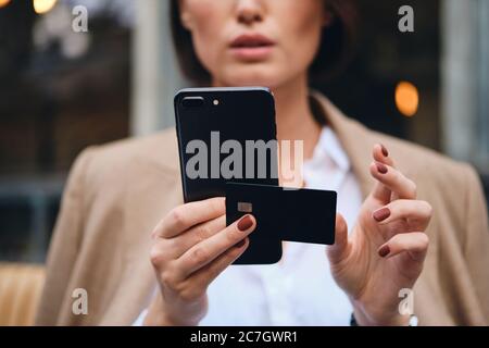 Close up businesswoman with credit card using cellphone outdoor Stock Photo