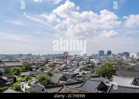 Jeonju, South Korea - A view of Hanok Village, Korean traditional house village behind the business district with modern office buildings. Panorama. Stock Photo