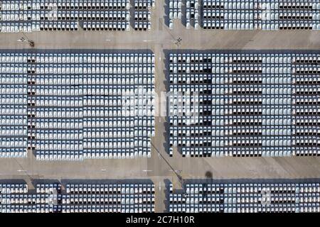 Aerial view of stock new cars parking in industrial zone waiting for sale export in southeast Asia. Transportation. Automobile industry. Stock Photo