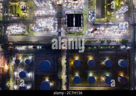 Aerial view oil and gas industrial, Refinery factory oil storage tank and pipeline steel at night