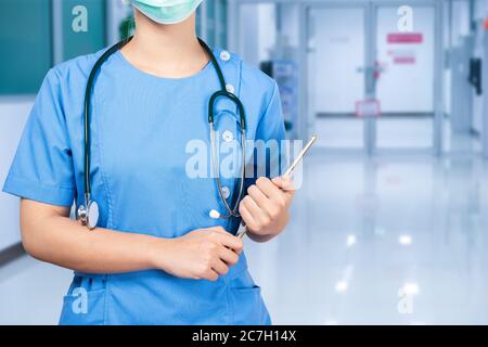 Portrait of young asian nurse wearing surgical mask Stock Photo
