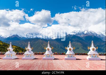 traditional Tibetan Buddhist style white pagoda with Meili snow mountain in background in Deqen, Shangri-la country,  Yunnan province, China Stock Photo