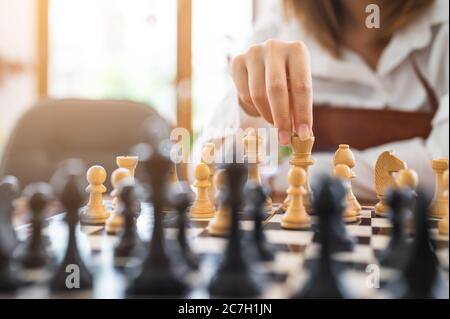 Woman playing chess in club, activity of weekend and complitation concept Stock Photo