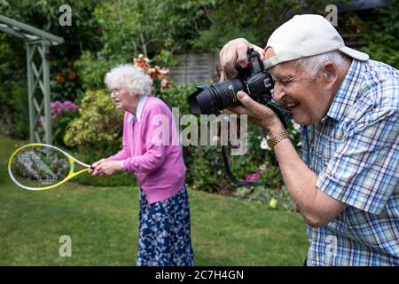 Married couple in their eighties enjoying activities in their garden, England, United Kingdom Stock Photo