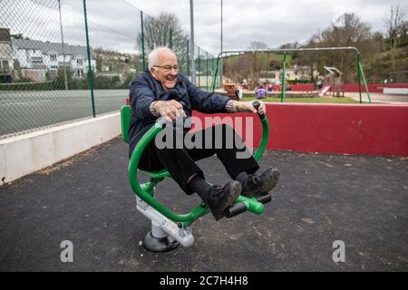 Elderly couple in their eighties at an exercise park trying out the apparatus together, Kingsbridge, Devon, England, United Kingdom Stock Photo
