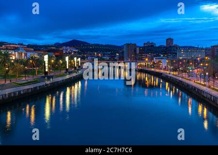 Europe, Spain, Basque Country, Vizcaya Province, Bilbao, view from the Pedro Arrupe Bridge over the Nervión and Bilbao at the blue hour Stock Photo