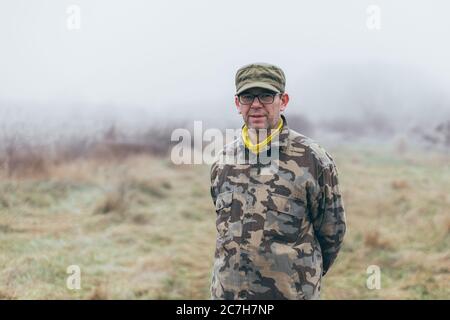 experienced soldier standing in the field Stock Photo