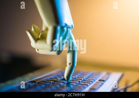 robotic hand typing on a computer keyboard Stock Photo