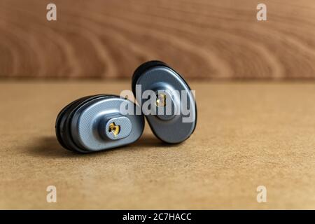 Selective focus shot of two-door locks on a brown surface Stock Photo