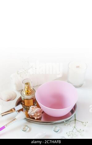 Beauty salon, table with creams, towels, brushes and bowl for mask on white background with copy space Stock Photo