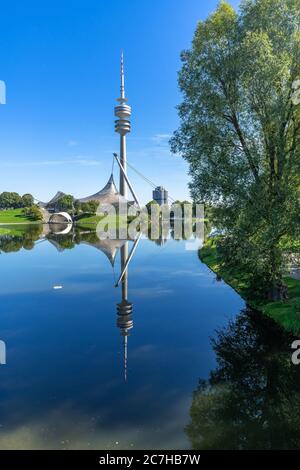 Europe, Germany, Bavaria, Munich, Olympiapark Munich, Olympic Tower reflected in the Olympic Lake Stock Photo