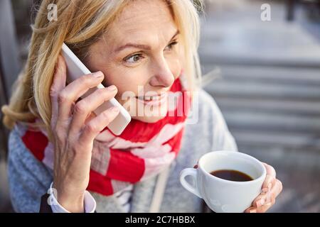 Happy cheerful lady holding cup of coffee in hand Stock Photo