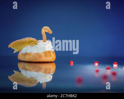 Selective focus shot of an orange shaped like a swan on a reflective surface Stock Photo