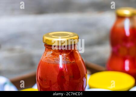 Bottle of tomato sauce, preserved canned food concept isolated. Stock Photo