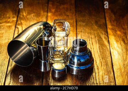 Bar ustensils, drink concept. Cocktail shaker accessories on a wooden board. Stock Photo