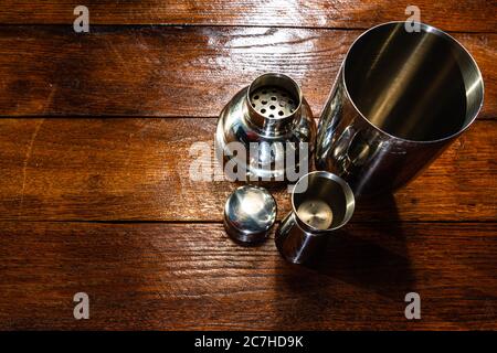 Bar ustensils, drink concept. Cocktail shaker accessories on a wooden board. Stock Photo
