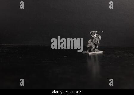 Grayscale selective focus shot of mythical creature riding a boar figurine Stock Photo