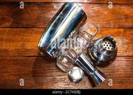 Bar ustensils, drink concept. Cocktail shaker accessories on a wooden board. Stock Photo