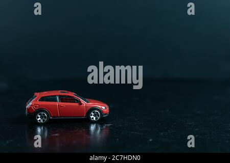 Selective focus shot of a red car on a black surface Stock Photo