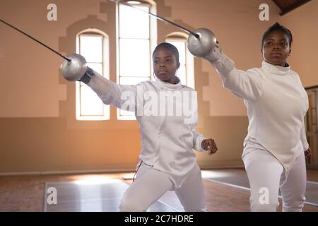 Two female fencers practicing fencing Stock Photo