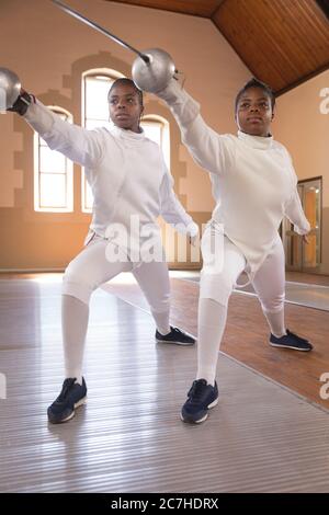 Two female fencers practicing fencing Stock Photo