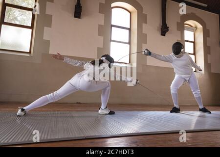 Two female fencers practicing fencing Stock Photo