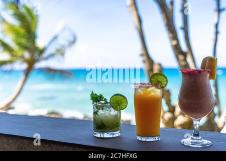 America, Caribbean, Greater Antilles, Dominican Republic, Cabarete, colorful cocktails against a beach backdrop at the Natura Cabana Boutique Hotel & Spa Stock Photo