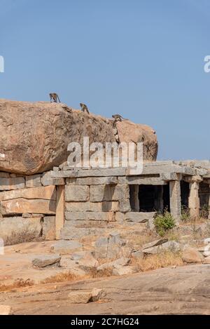 Ruin in dry rocky landscape with monkeys Stock Photo