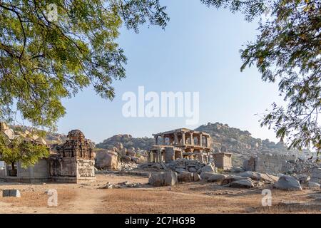 Temple ruins behind branches with a blue sky Stock Photo