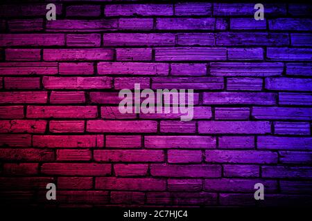 Neon light on brick walls that are not plastered background and texture. Lighting effect red and blue neon background vertical of empty brick basement Stock Photo