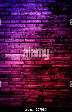 Neon light on brick walls that are not plastered background and texture. Lighting effect red and blue neon background vertical of empty brick basement Stock Photo