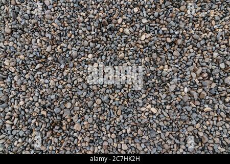 Top view of the pebbles stone on the floor. beautiful small stone on the beach background texture. Stock Photo