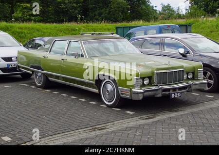 Pieterburen, the Netherland - July 16, 2020: Green Lincoln Continental Mark III parked on a public parking lot. Nobody in the vehicle. Stock Photo