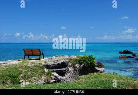 A bench overlooks the sea in Beautiful Bermuda Stock Photo