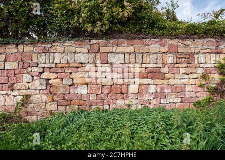 Red sandstone dry stone wall in the vineyard Stock Photo