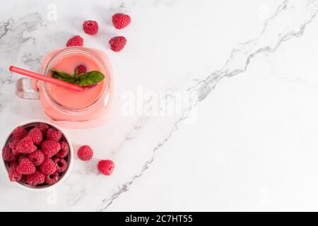 Raspberry smoothie in a glass jar. Top view with copy space. Stock Photo