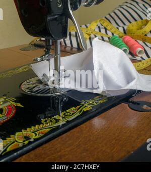 Close-up of Sewing Machine Needle with Thread and fabric. the conceptual idea for dressmaking. Stock Photo