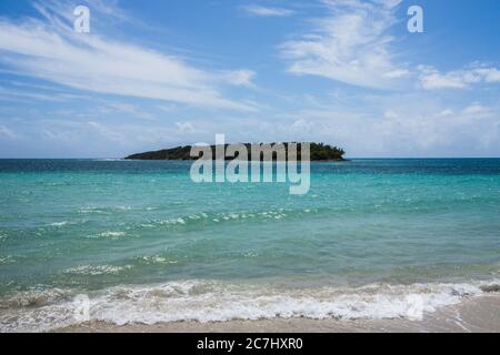 View of a small, secluded island in the middle of the Caribbean Sea seen from a beach in Vieques, Puerto Rico Stock Photo